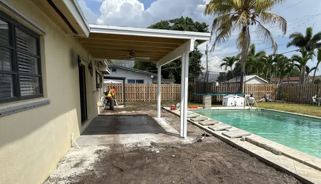 Old patio removed, ground graded along the house and pool