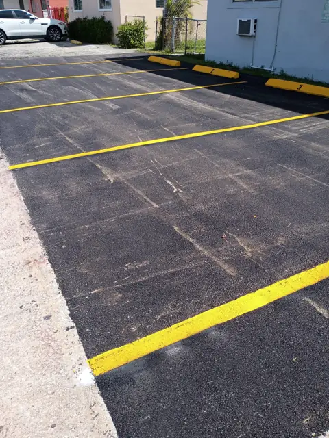 Repaved and striped, with numbered wheel stops