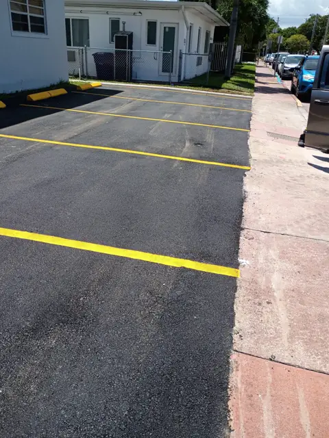 Parking Lot Repaving, Miami Beach: New asphalt tied in flush with the sidewalk