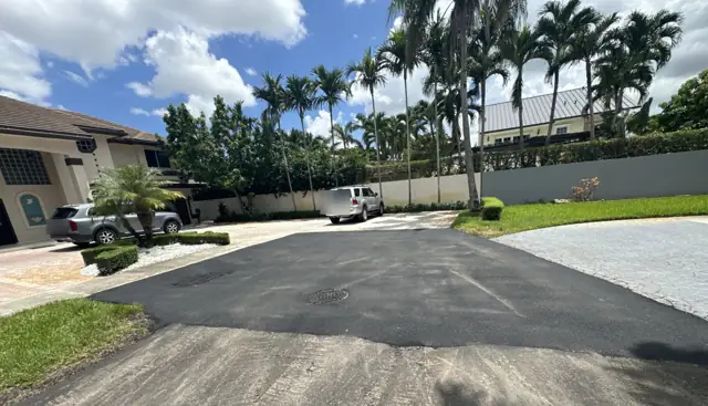 Residential Street Paving, Miami Lakes: After: finished tie-in at a driveway, manhole and inlet