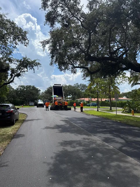 NE 103rd Street — FDOT: Paver and crew working under the tree canopy