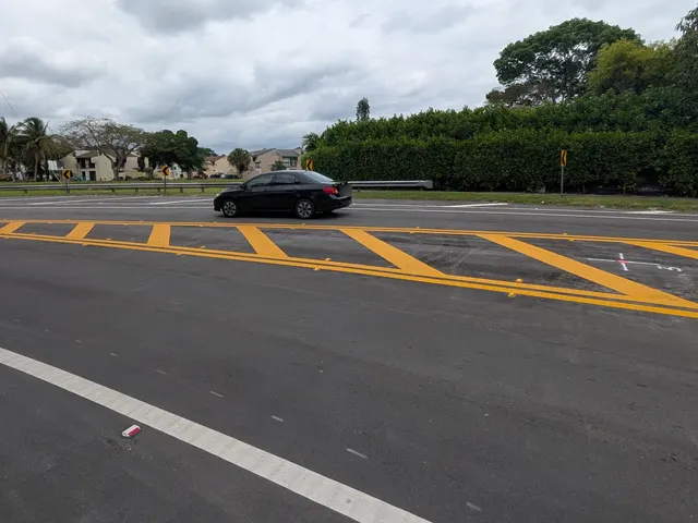 Palmetto Bay Median, Bike Lane & Striping Improvements: Thermoplastic median crosshatching and white lane lines on the curve