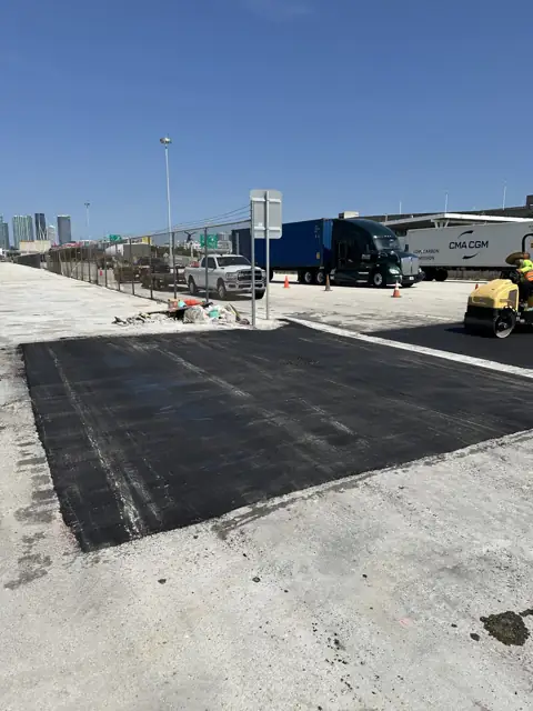 Asphalt Patching, PortMiami: Finished patch across the truck lane, roller completing compaction