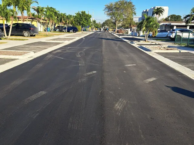 Sweetwater Neighborhood Roadway Improvements: Asphalt mat behind the paver with driveway aprons already placed