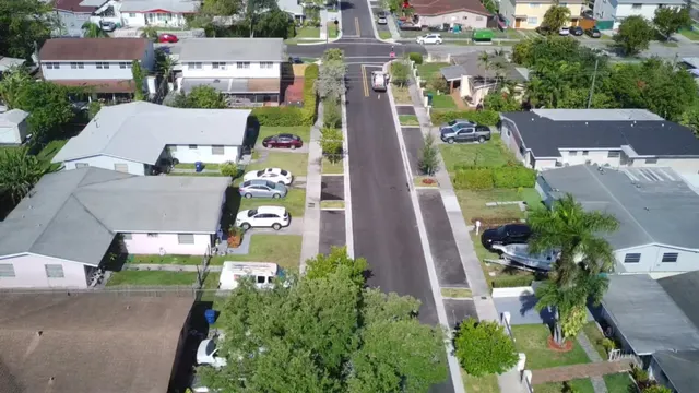 Sweetwater Neighborhood Roadway Improvements: Aerial of the reconstructed block: new asphalt, sidewalk, sodded swales and driveway aprons