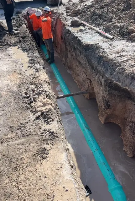 West Little River Sewer & Resurfacing: Crew joining pipe in the trench