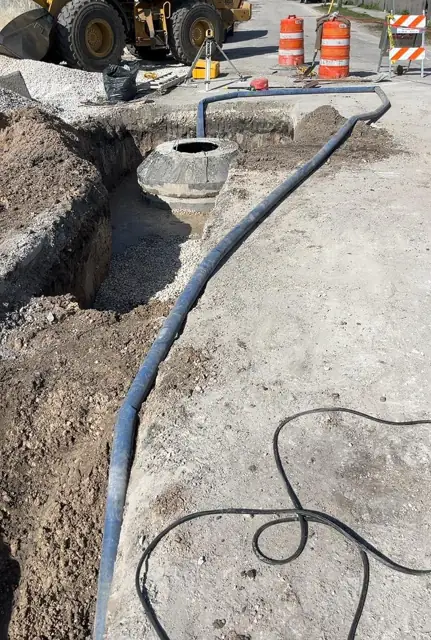 West Little River Sewer & Resurfacing: Dewatering line running to the manhole excavation