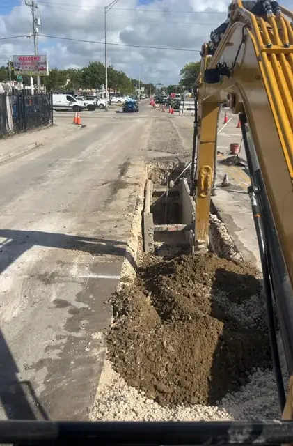 West Little River Sewer & Resurfacing: Excavator opening the trench along NW 1st Place