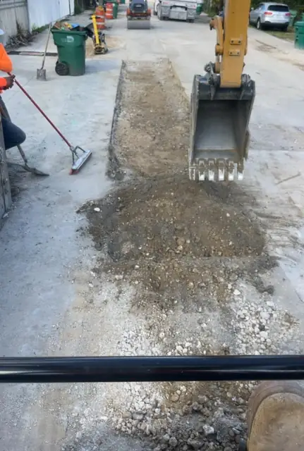 West Little River Sewer & Resurfacing: Spreading limerock base over the restored trench