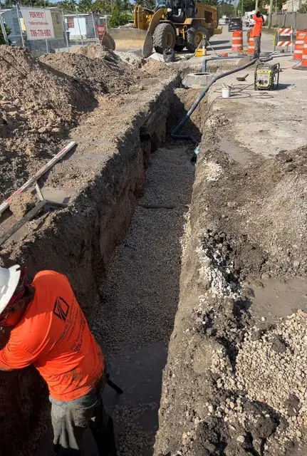 West Little River Sewer & Resurfacing: Bedding placed ahead of the pipe, loader staged behind