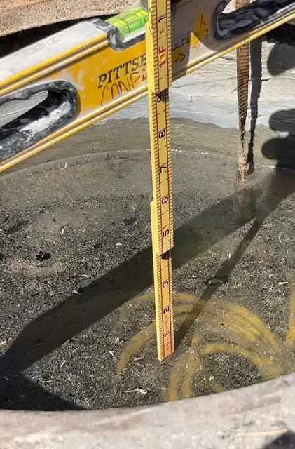 West Little River Sewer & Resurfacing: Checking pipe invert with the grade rod